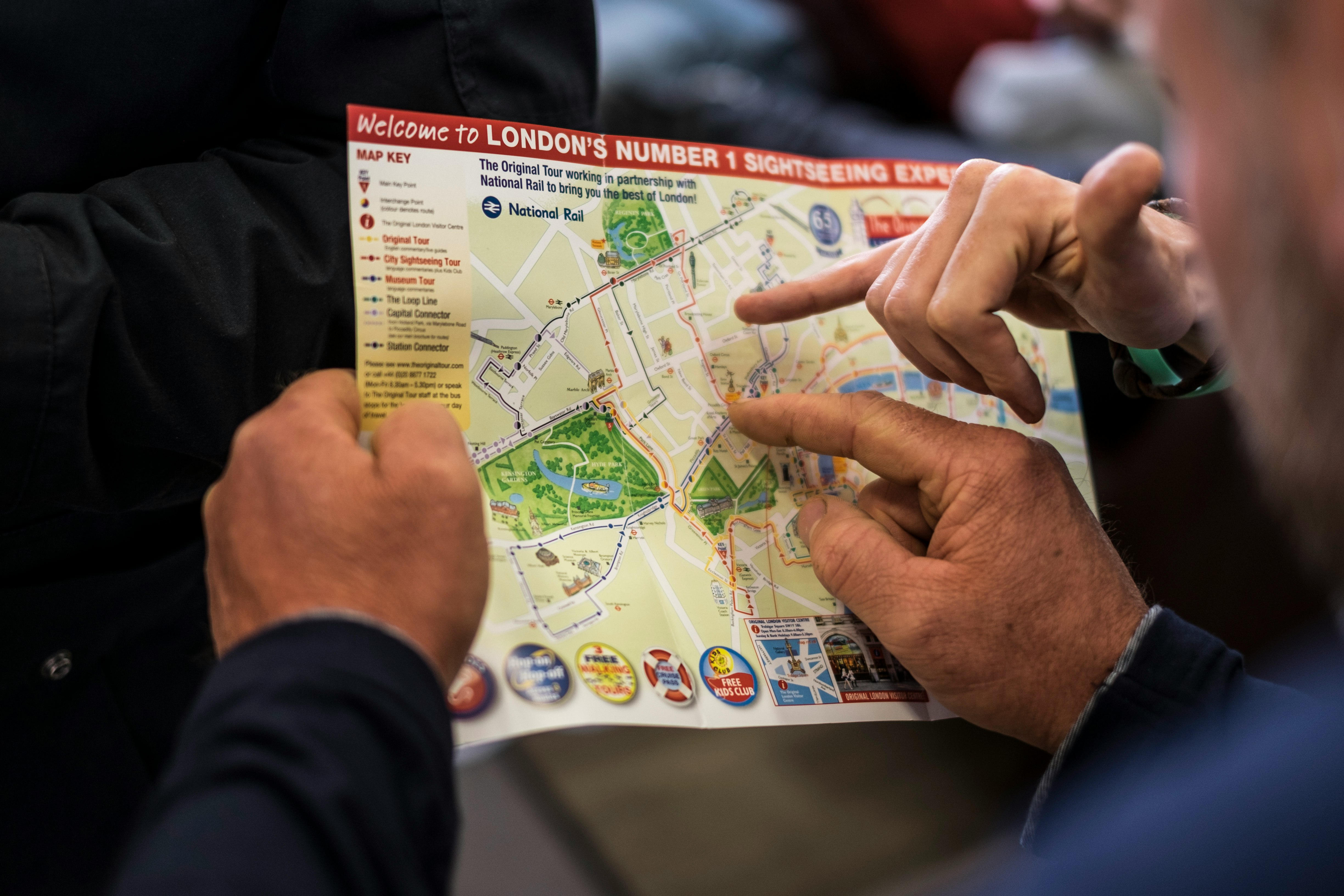 two people pointing at London's number one sightseeing map